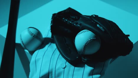 Close-Up-Studio-Baseball-Still-Life-With-Bat-Ball-Catchers-Mitt-And-Team-Jersey-With-Blue-Lighting
